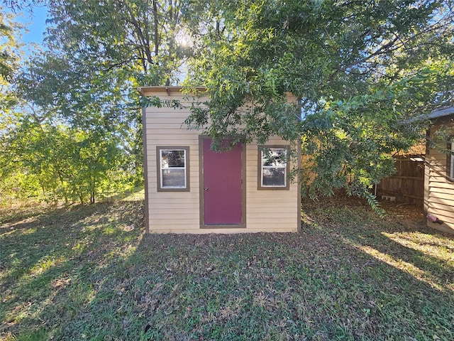 view of outbuilding featuring a lawn