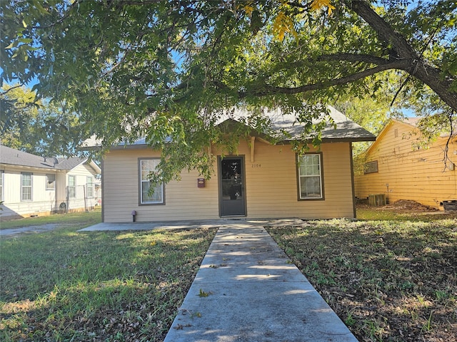 bungalow-style home featuring central AC and a front lawn