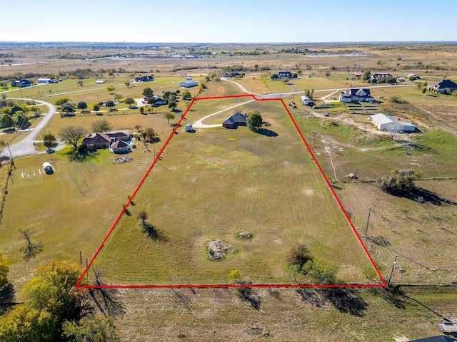 birds eye view of property with a rural view