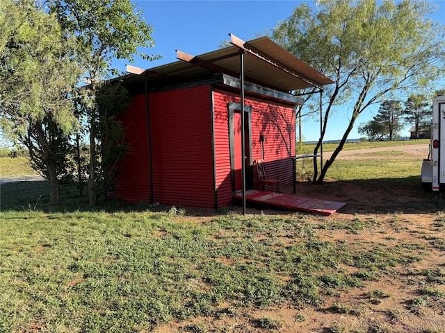 view of outdoor structure featuring a lawn