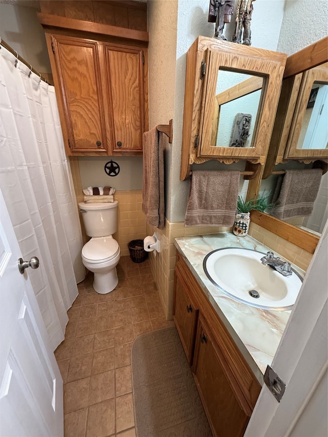 bathroom featuring tile patterned floors, vanity, and toilet