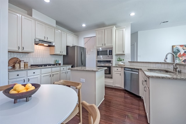 kitchen with dark hardwood / wood-style floors, sink, white cabinetry, and stainless steel appliances