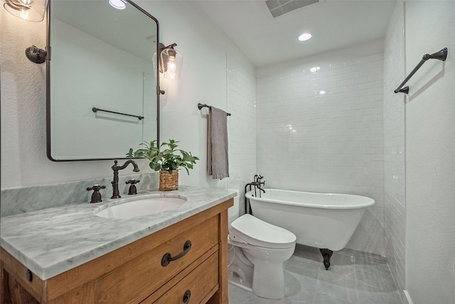 bathroom featuring vanity, toilet, and a bathing tub