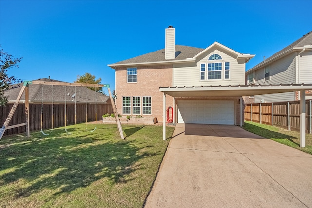 back of house featuring a yard and a garage