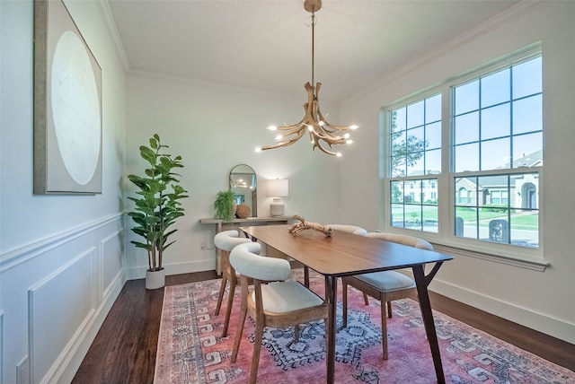 dining area with a chandelier, dark hardwood / wood-style floors, and crown molding