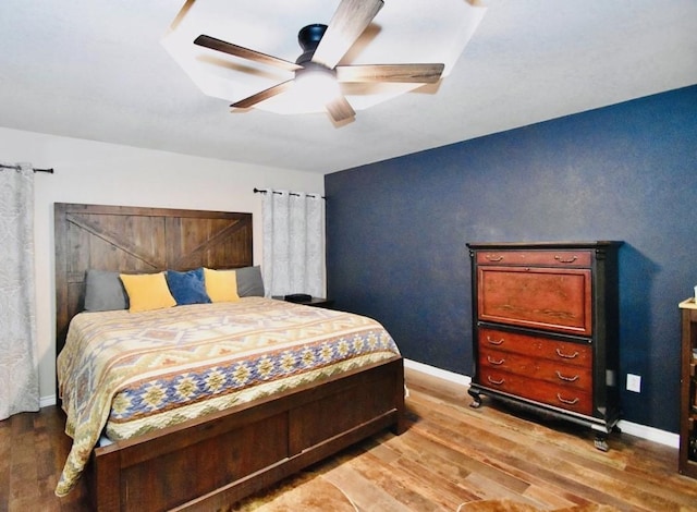 bedroom featuring ceiling fan and hardwood / wood-style floors