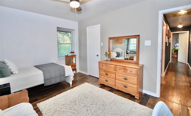 bedroom with ceiling fan and dark hardwood / wood-style flooring