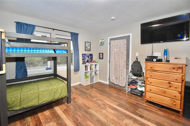 bedroom featuring a textured ceiling and hardwood / wood-style flooring