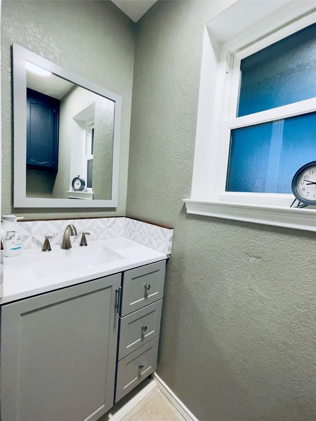 bathroom featuring vanity and tasteful backsplash