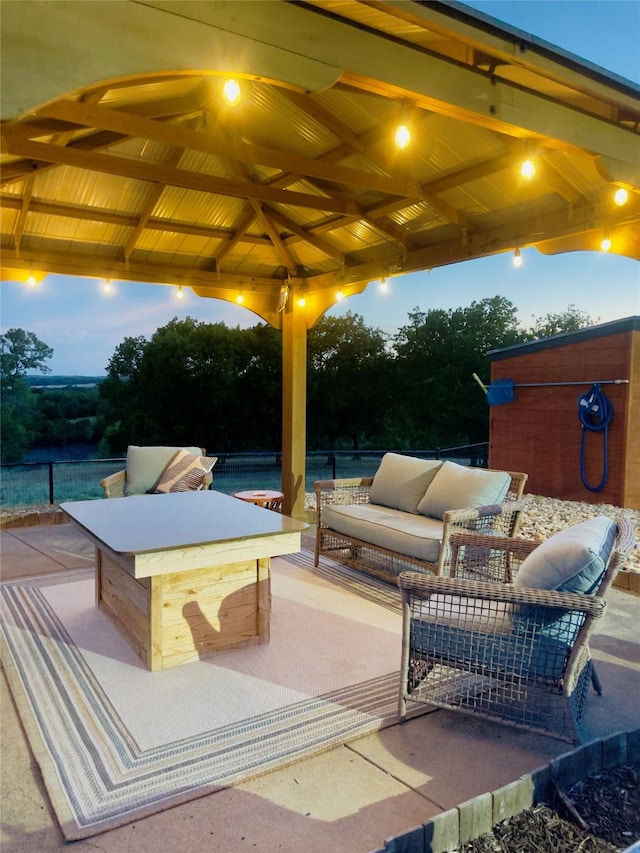 patio terrace at dusk with a gazebo and an outdoor living space