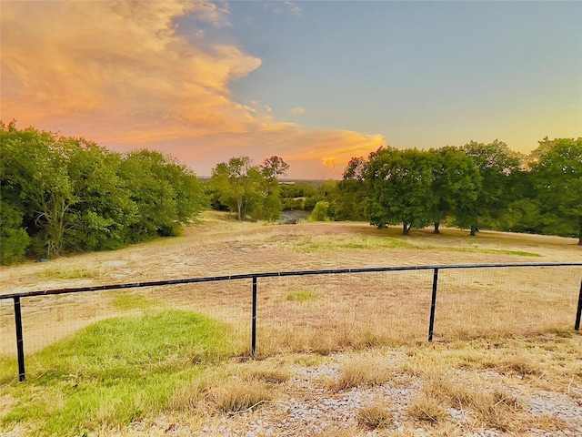 yard at dusk with a rural view