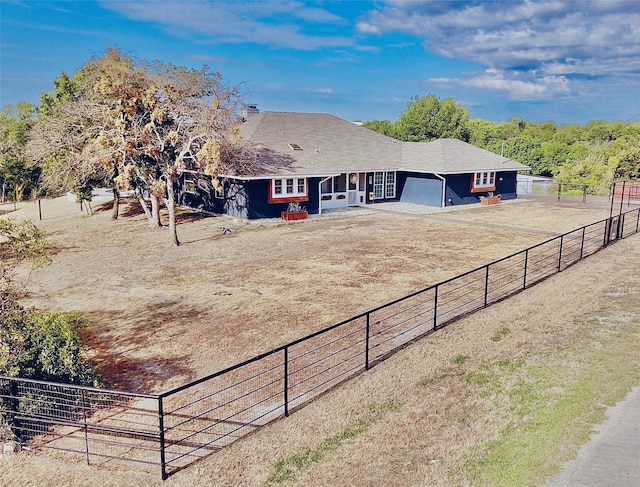 view of front of property with a rural view and a garage