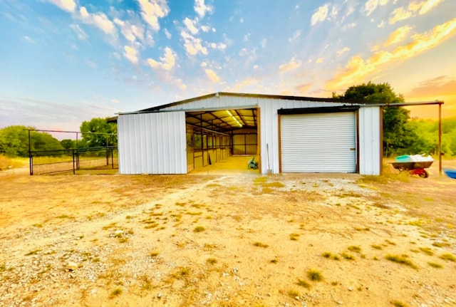 view of garage at dusk