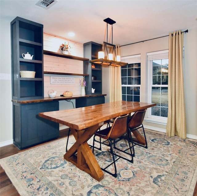 dining area with plenty of natural light and dark wood-type flooring