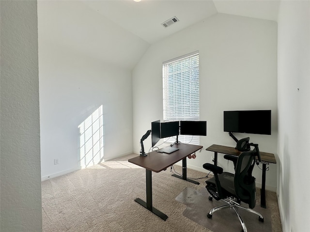 carpeted office featuring vaulted ceiling