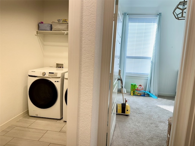 laundry room with washer / clothes dryer and light carpet