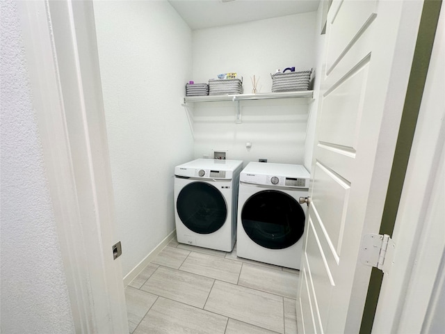 clothes washing area with separate washer and dryer