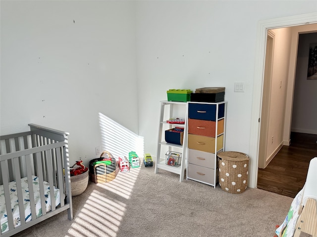 bedroom featuring carpet floors and a nursery area