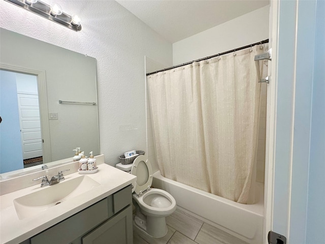 full bathroom with tile patterned floors, vanity, toilet, and shower / bath combo with shower curtain