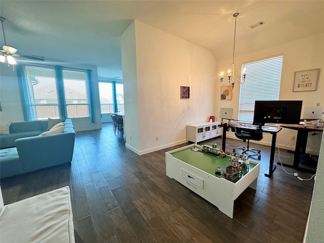 rec room with dark wood-type flooring and ceiling fan with notable chandelier