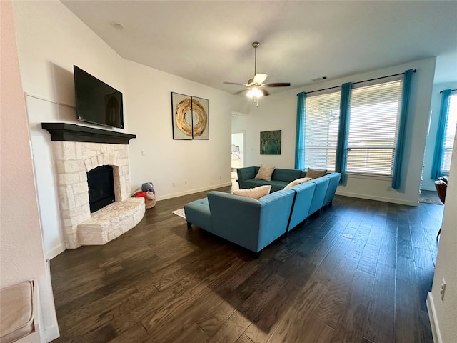 living room with a fireplace, dark hardwood / wood-style flooring, and ceiling fan