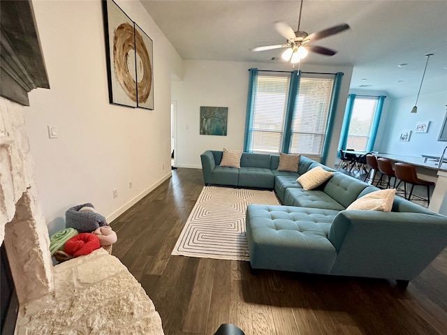 living room featuring ceiling fan and dark hardwood / wood-style flooring