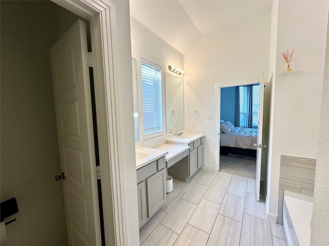 bathroom with a bathing tub and vanity