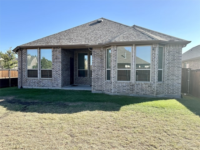 back of house featuring a lawn