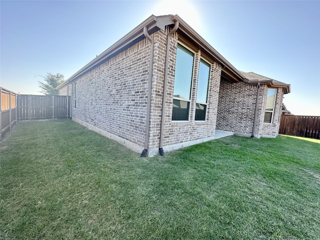 view of home's exterior with a lawn