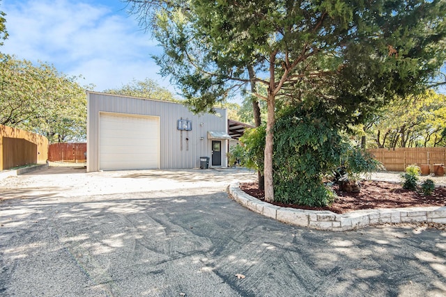 exterior space featuring an outbuilding and a garage