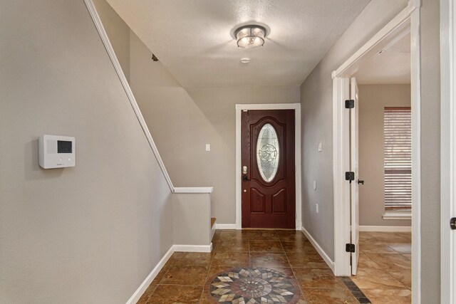 foyer featuring a textured ceiling