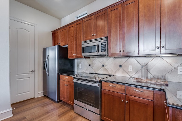 kitchen with tasteful backsplash, light hardwood / wood-style flooring, and appliances with stainless steel finishes