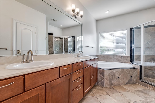 bathroom featuring tile patterned flooring, shower with separate bathtub, and vanity