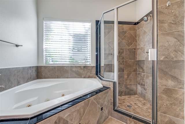 bathroom featuring plenty of natural light and shower with separate bathtub