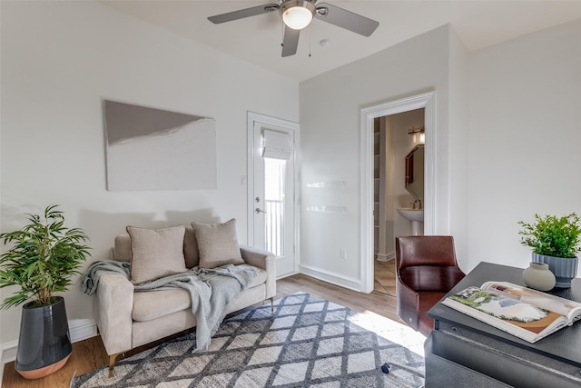 living room with hardwood / wood-style floors and ceiling fan