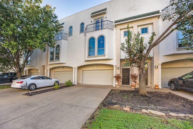 view of front of house with a garage and a balcony