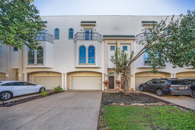 view of property featuring a balcony and a garage