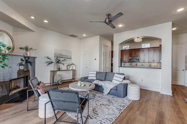 living room featuring ceiling fan and light wood-type flooring