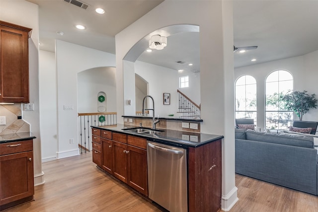 kitchen featuring ceiling fan, dishwasher, sink, light hardwood / wood-style flooring, and decorative backsplash