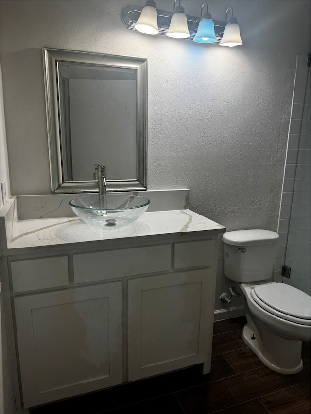 bathroom featuring hardwood / wood-style floors, vanity, and toilet