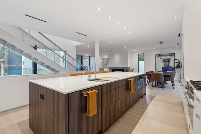 5103 Vickery Blvd, Dallas, TX 75206 - kitchen with a sink, modern cabinets, a spacious island, light wood-style flooring, and recessed lighting