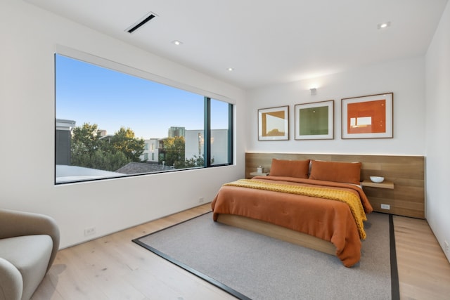 bedroom with hardwood / wood-style flooring