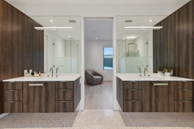 bathroom with hardwood / wood-style flooring, vanity, and wood walls