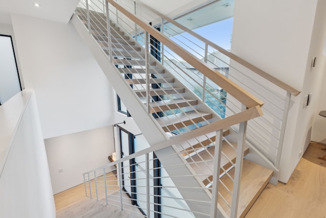 stairway with hardwood / wood-style floors