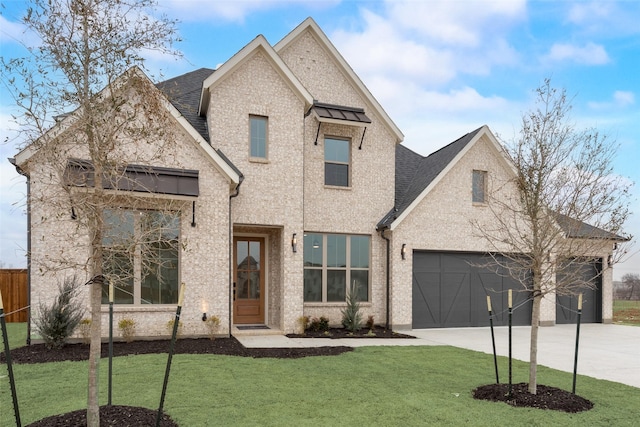 view of front of house with a garage and a front lawn