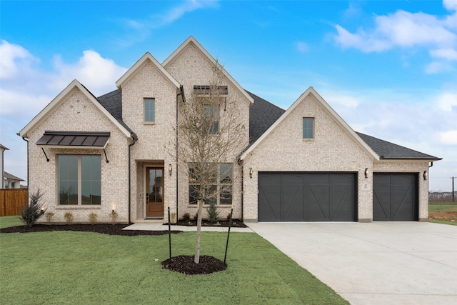 view of front of house featuring a garage and a front yard