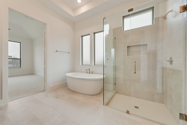 bathroom with separate shower and tub and tile patterned floors