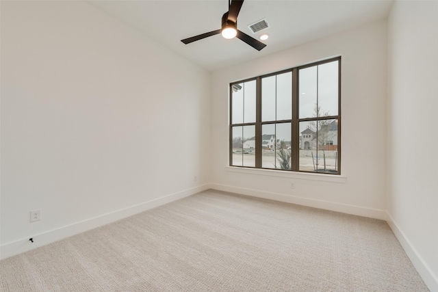 spare room featuring ceiling fan and carpet flooring