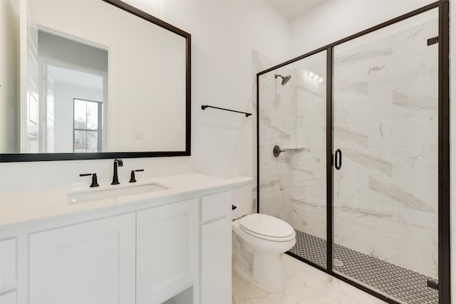 bathroom with a shower with door, vanity, and toilet