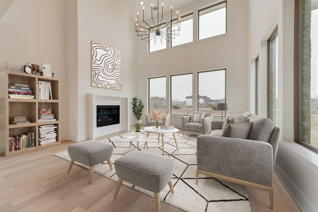 living room with a chandelier and light hardwood / wood-style flooring